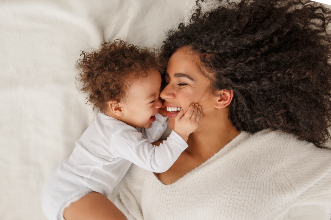 A mother laughing with her baby